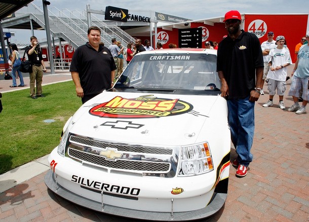 NFL  star , Randy Moss (right)  and  business  partner , David  Dollar  of   Randy Moss  Motorsports Inc   pose  alongside  the #81  Moss  Motorsports   Chevrolet  during  the  announcement    of   his  vehicle's  entry  in  the  Craftsman  Truck  Series  .   The  venue  was  at   Daytona  International  Speedway  ,  Daytona  Beach , Florida,.  picture  appears  courtesy  of  getty images/  Geoff Burke ...................   