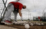 St. Louis Cardinals' Albert Pujols gathers balls after hitting in a cage during spring training baseball Tuesday, Feb. 23, 2010, in Jupiter, Fla.