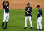 New York Yankees third baseman Alex Rodriguez, left, shortstop Derek Jeter, center and catcher Jorge Posada stretch on the field as the Yankees full squad worked out for the first time during spring training baseball at Steinbrenner Field in Tampa, Fla., Wednesday, Feb. 24, 2010.
