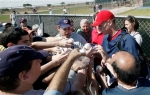 Washington Nationals pitcher Stephen Strasburg (red cap) signs autographs after spring training baseball practice, Sunday, Feb. 21, 2010, in Viera, Fla.