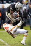 Oakland Raiders wide receiver Jacoby Ford (12) catches a pass over Kansas City Chiefs cornerback Brandon Flowers during the fourth quarter of an NFL football game in Oakland, Calif., Sunday, Nov. 7, 2010. Oakland won 23-20 in overtime. AP Photo/Paul Sakuma