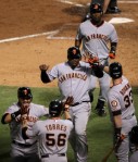 Cody Ross #13, Edgar Renteria #16, Juan Uribe #5, Andres Torres #56 and Aaron Rowand #33 of the San Francisco Giants celebrate after they scored on a 3-run home run hit by Renteria #16 in the seventh inning against the Texas Rangers in Game Five of the 2010 MLB World Series at Rangers Ballpark in Arlington on November 1, 2010 in Arlington, Texas.