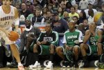 Charlotte Bobcats forward Eduardo Najera (21) looks to score as Boston Celtics forward Kevin Garnett, second from left, guard Rajon Rondo, center, guard Ray Allen, second from right, and forward Paul Pierce (34) sit on the bench in the fourth quarter of an NBA basketball game in Charlotte, N.C., Saturday, Dec. 11, 2010. The Celtics won 93-62. AP Photo/Bob Leverone .....