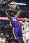 Los Angeles Lakers' Kobe Bryant (24) dunks against Chicago Bulls' Carlos Boozer (5) during the first quarter of an NBA basketball game in Chicago, Friday, Dec. 10, 2010. AP Photo/Nam Y. Huh .......