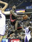 Miami Heat forward LeBron James, center, drives to the basket between Sacramento Kings Omri Casspi, of Israel, left, and Pooh Jeter during the fourth quarter of an NBA basketball game in Sacramento, Calif., Saturday, Dec. 11, 2010. The Heat beat the Kings 104-83. AP Photo/Rich Pedroncelli .....